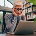 stressed senior woman using laptop