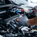 Mechanic repairing engine at garage workshop