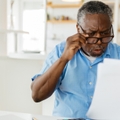 amazed pensioner looking at bills