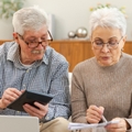 senior couple reviweing budget together