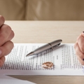 husband wife signing divorce documents