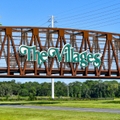 the Villages sign over Steel bridge