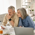 Retired couple reviewing bills together at home 