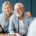 Senior couple signing agreement with finance advisor