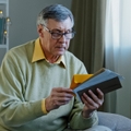 Caucasian man checking sorting letters in living room