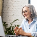 senior businesswoman sitting at the desk using laptop