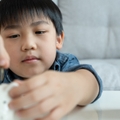 children putting coin for saving