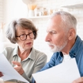 Concerned senior couple doing paperwork