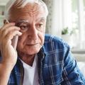 tensed senior man talking on mobile phone 