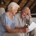 senior couple discussing over medical bills