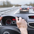 close up of hands on steering wheel