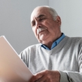 senior man reading a paper document