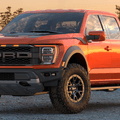 A new orange Ford F-150 Raptor is shown in a parking lot.