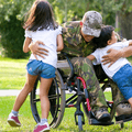 Disabled veteran hugging children