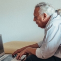 Older man working on laptop