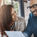 Smiling couple working on bills