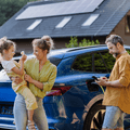 Couple with child in front of a car and house