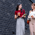 two professionally dressed people walking down street