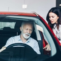 man choosing a new car at car showroom