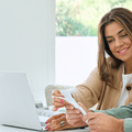couple sitting at laptop with papers