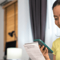 person paying bills on phone