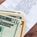 A stack of US Dollar bills on a table