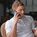 person on phone with credit card