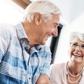 happy senior couple in home planning for retirement