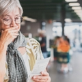 senior woman checks her grocery receipt