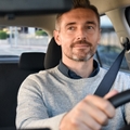happy mature man driving car 
