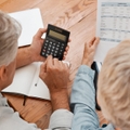 senior couple with calculator planning financial investments