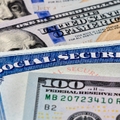 social security benefits identification card with dollar bills