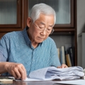 elderly man organizing documents