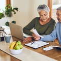 senior couple with bills