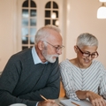 senior couple calculating their expenses