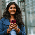 Woman looking at phone in city