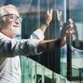 businessman standing near office window