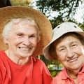 Two senior women smiling in the garden