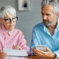 senior couple checking bills