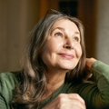 Older woman smiling and looking up