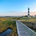 North Carolina outer banks showing lighthouse in background and bridge next to water in foreground