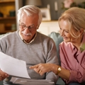 Happy older couple with paperwork