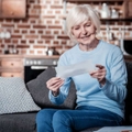 senior woman checking bill