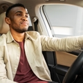 Man driving car with tan leather interior