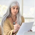 older woman reviewing papers