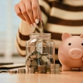 A woman holds a piggy bank