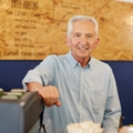 An old man working at a coffee shop