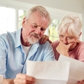 Concerned couple reviewing papers