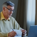 Mature man with laptop and notebook