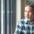 Mature man looking out window